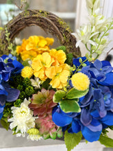 Load image into Gallery viewer, Blue Hydrangea &amp; Yellow Primrose Floral Arrangement in Wooden Dough Bowl – High-End Spring Table Centerpiece